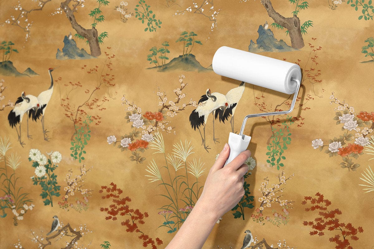 'Elegant Vintage Crane and Floral Mural Wallpaper, warm earth tones, applying with paint roller, close-up.'