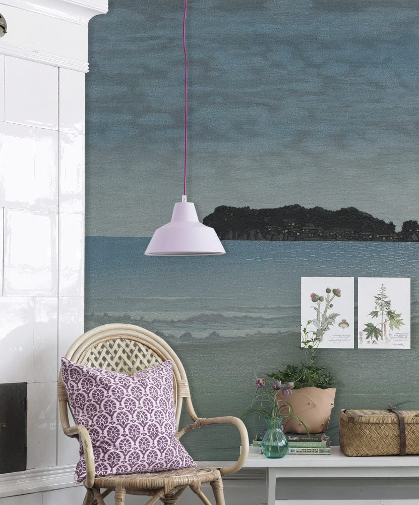 Mystical Moonlit Seascape mural wallpaper in living room with wicker chair, lavender cushion, white tiles.
