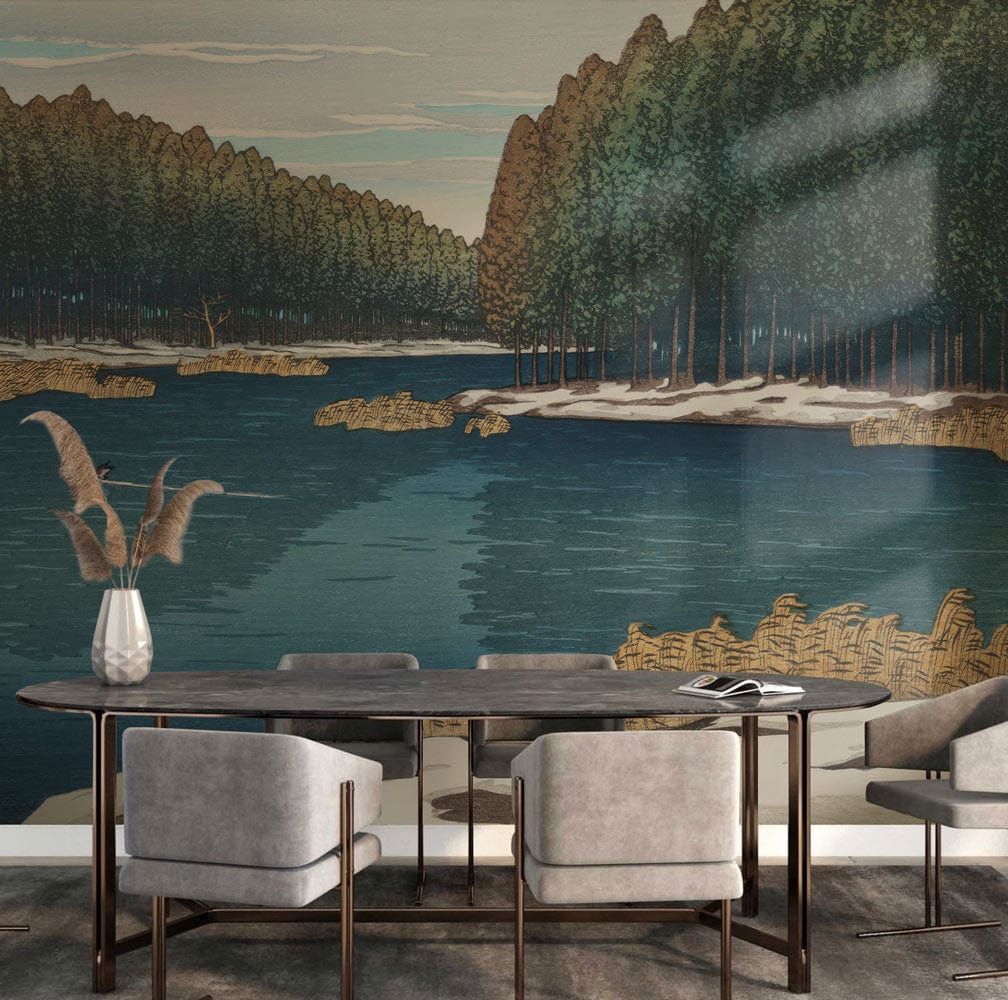 Scenic mural wallpaper depicting winter lake and forest behind modern grey chairs and dark wood table.