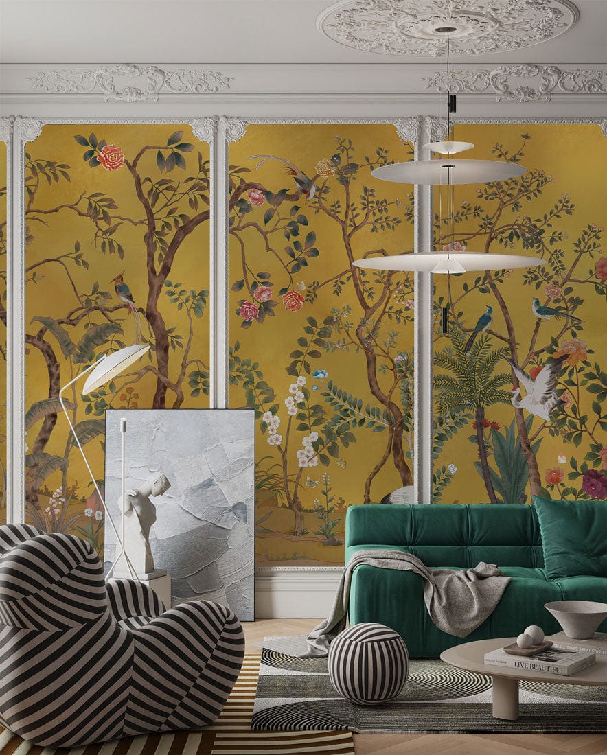 Golden Chinoiserie Garden Mural Wallpaper features vibrant birds, lush flowers, teal sofa, elegant setting.
