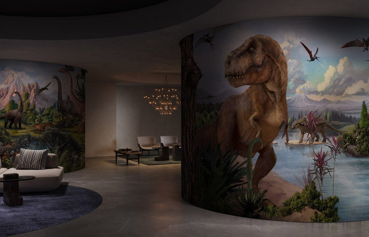 Prehistoric Dinosaurs Landscape Mural Wallpaper in modern room, grey concrete flooring, elegant sofas.