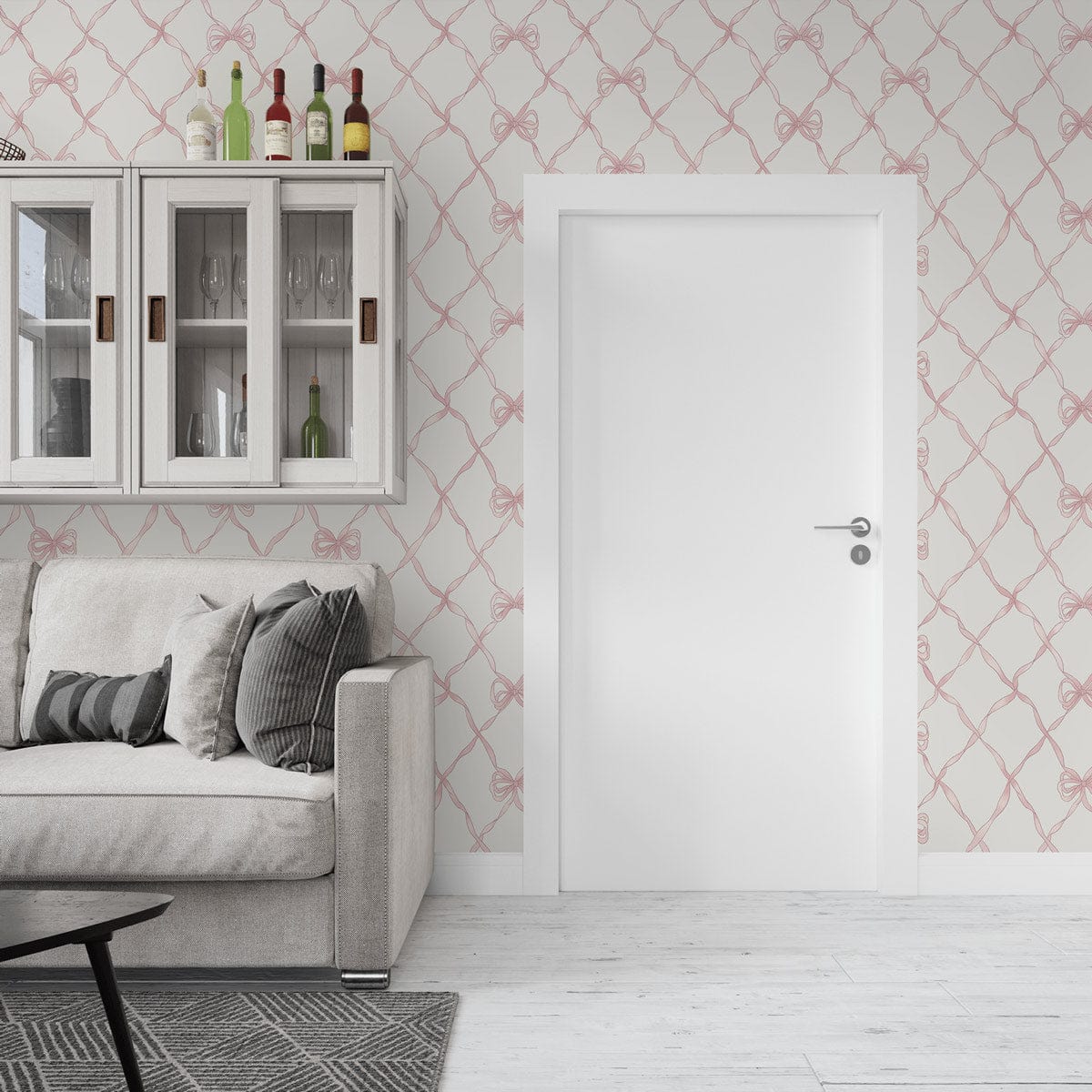 Elegant pink bow wallpaper with grey sofa, glass cabinet, white door, and wooden flooring in lounge.