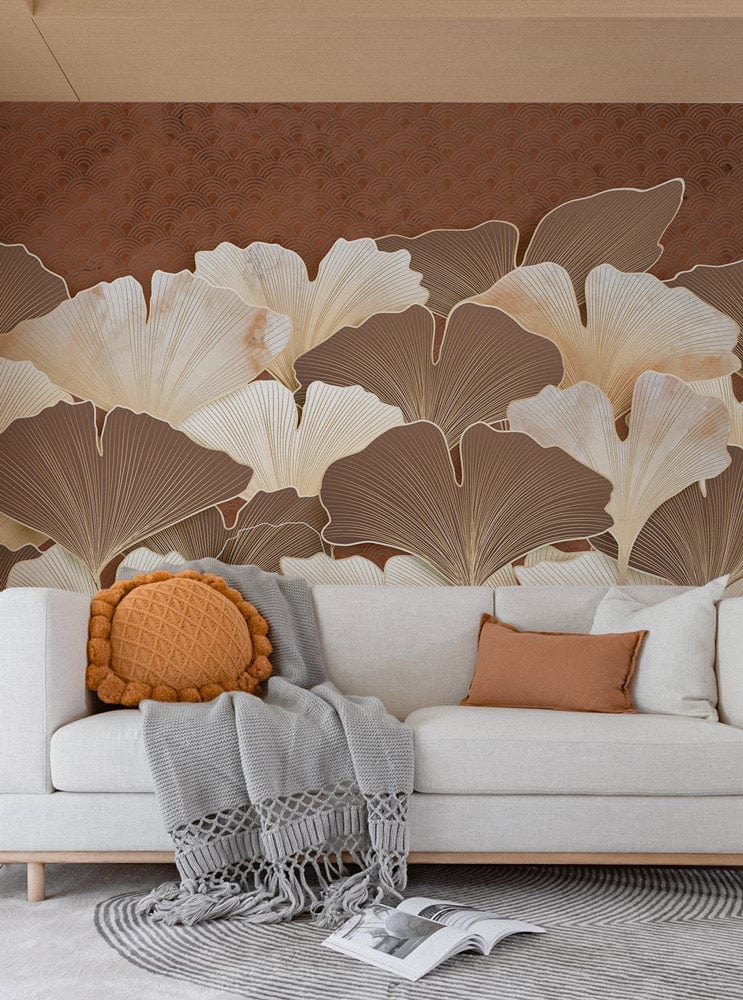 Elegant Ginkgo mural wallpaper with beige sofa, orange cushion, grey throw, round rug, cosy interior.
