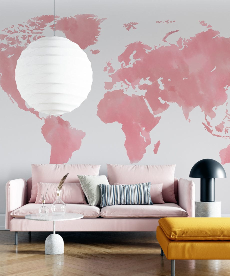 Blush Pink Watercolour World Map Mural Wallpaper, modern interior, pastel sofa, mustard seat, parquet floor.