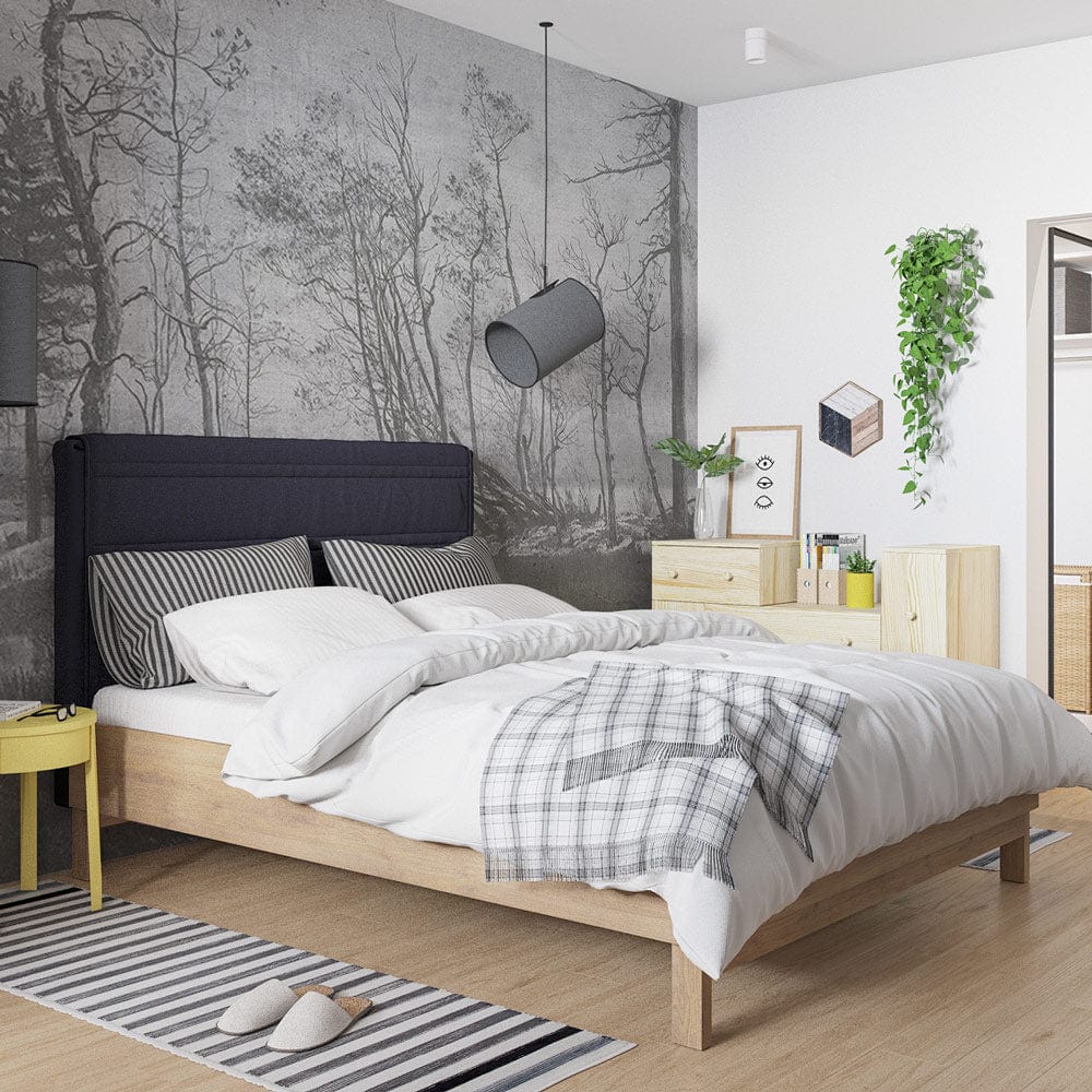 Serene Monochrome Forest Wallpaper in a modern bedroom with wooden bed, grey headboard, and striped rug.