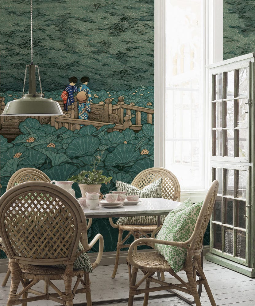 Serene Green Lotus Garden Mural Wallpaper in dining room with wicker chairs, wooden table, scenic mural.