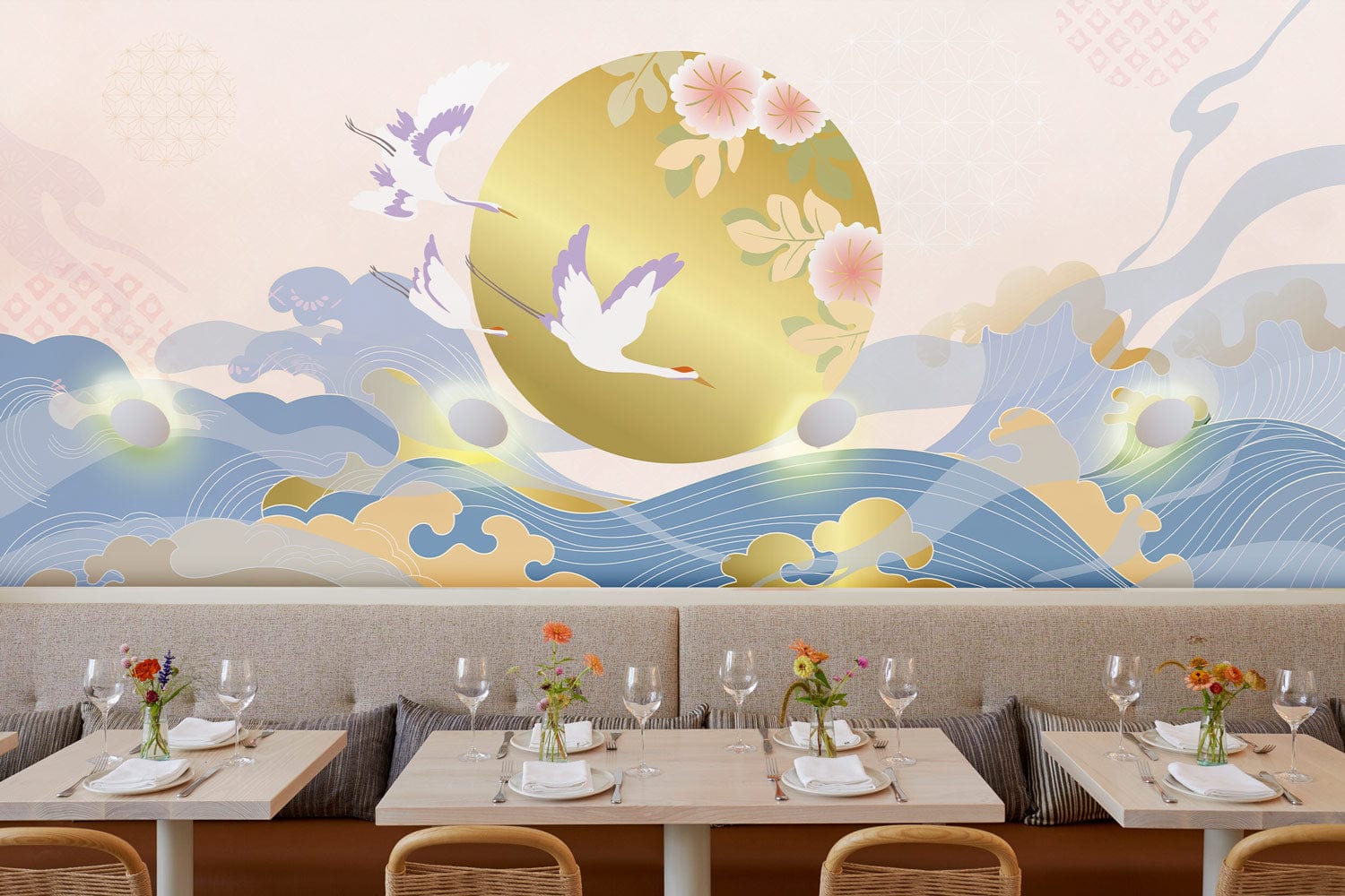 Elegant wallpaper with oriental birds, waves; pastel and gold hues enhance dining room with wooden chairs.