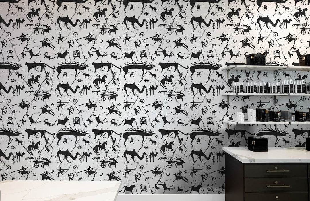 Monochrome Prehistoric Petroglyph Wallpaper in modern kitchen setting with white countertops and grey cabinets.
