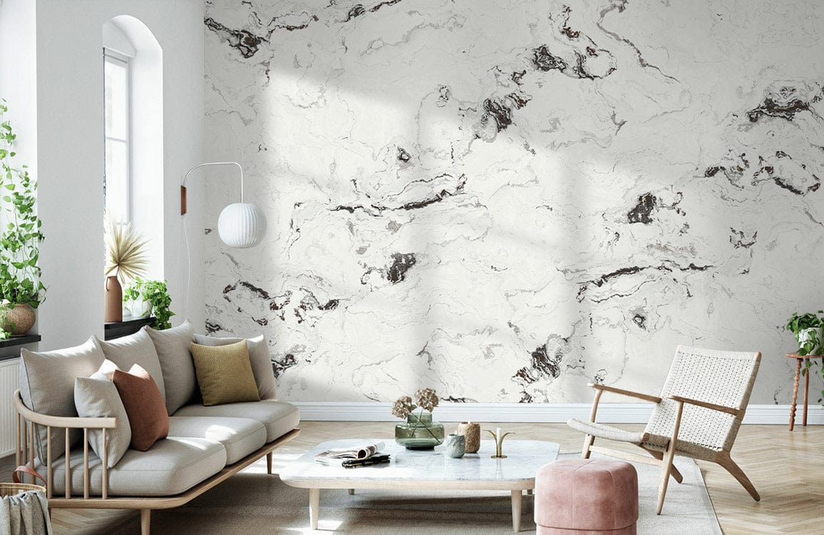 Elegant white marble effect wallpaper in modern living room with light sofa, rattan chair, wooden floor.