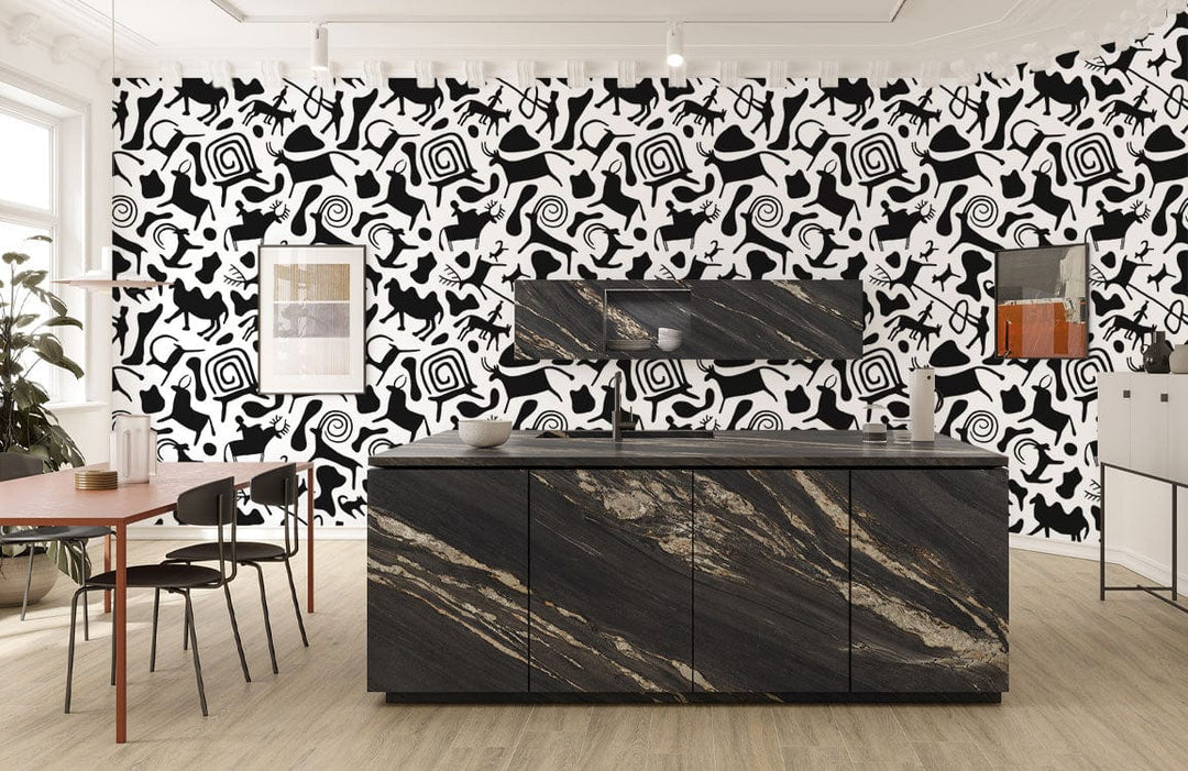 Monochrome tribal abstract pattern mural wallpaper in modern kitchen with marble island and wood flooring.