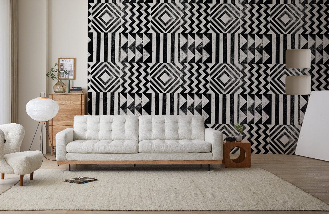 Bold Monochrome Geometric Pattern Wallpaper in modern living room with white sofa and wooden flooring.