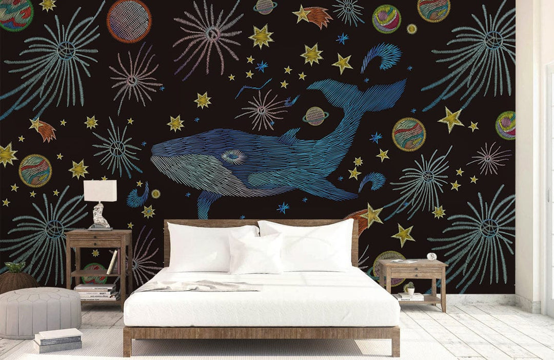 Cosmic Whale Adventure Mural Wallpaper on dark wall, light wood furniture, white bedding, light wood flooring.