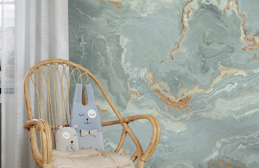 Marble effect sage and rust wallpaper with rattan chair in cosy room, complementing abstract design.