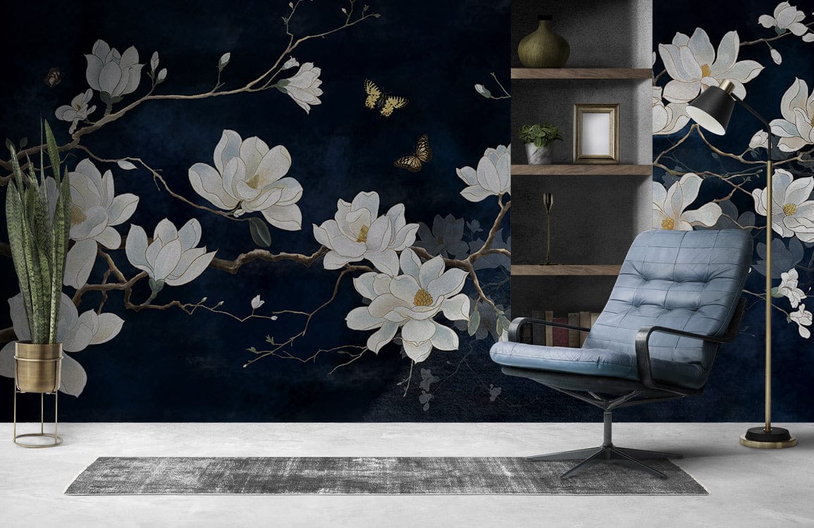 Elegant white magnolia mural on midnight blue, grey modern chair, sleek shelving in stylish room.