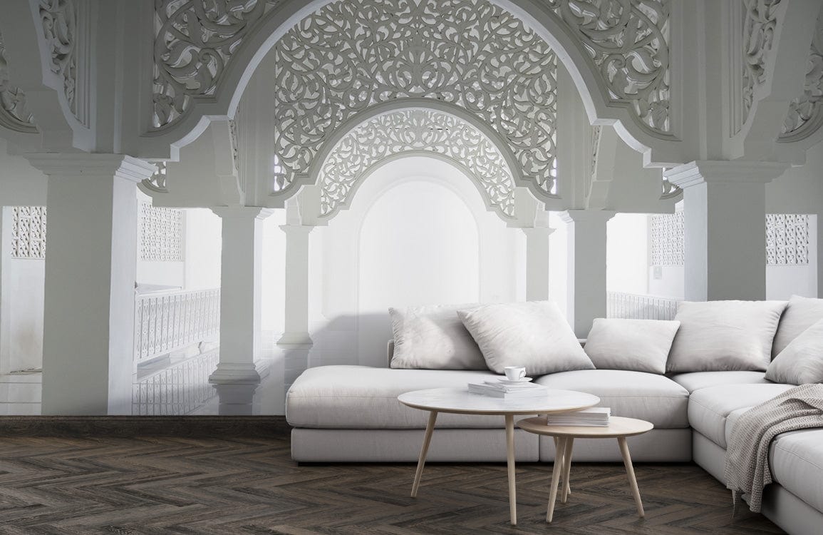 Ornate white archway mural with grey sofa, hardwood flooring, and round coffee table in living room.