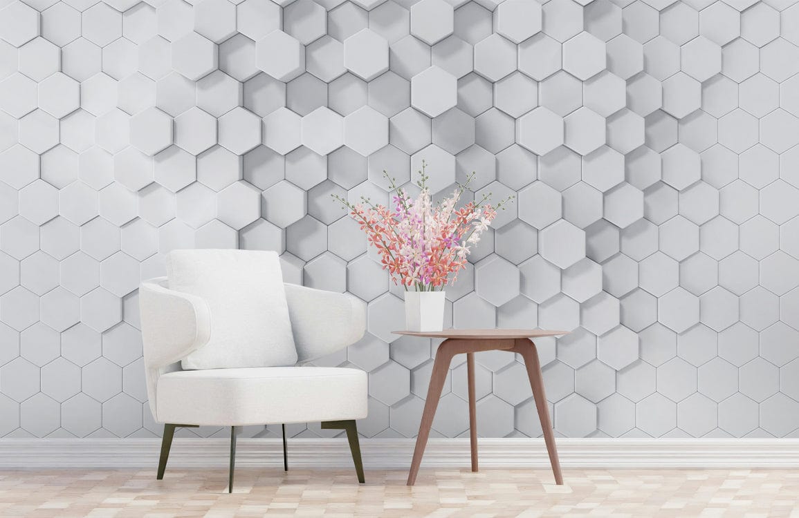 Geometric white hexagonal 3D wallpaper, minimalist design, white armchair, wooden table, laminate flooring.