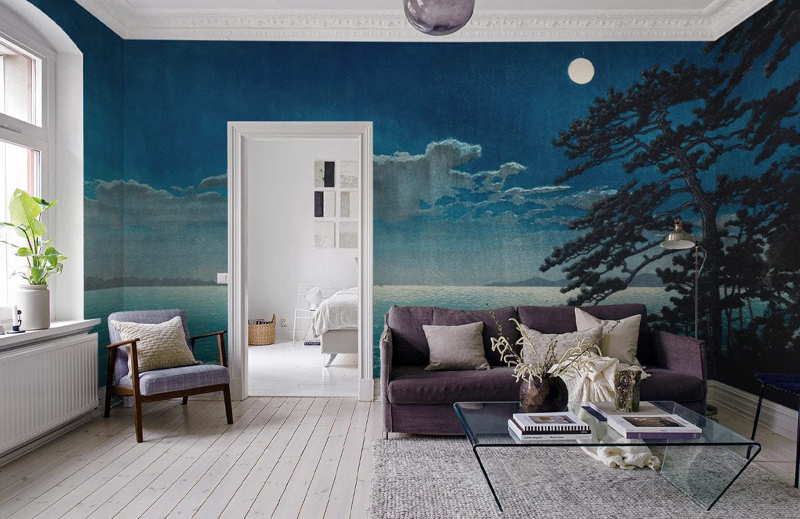Midnight Blue Mural Wallpaper featuring moonlit ocean scene, grey sofa, hardwood flooring in stylish living room.