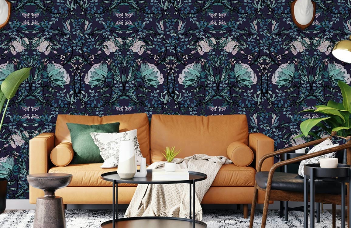 Luxurious teal floral wallpaper in living room, featuring a tan sofa and stylish dark round tables.