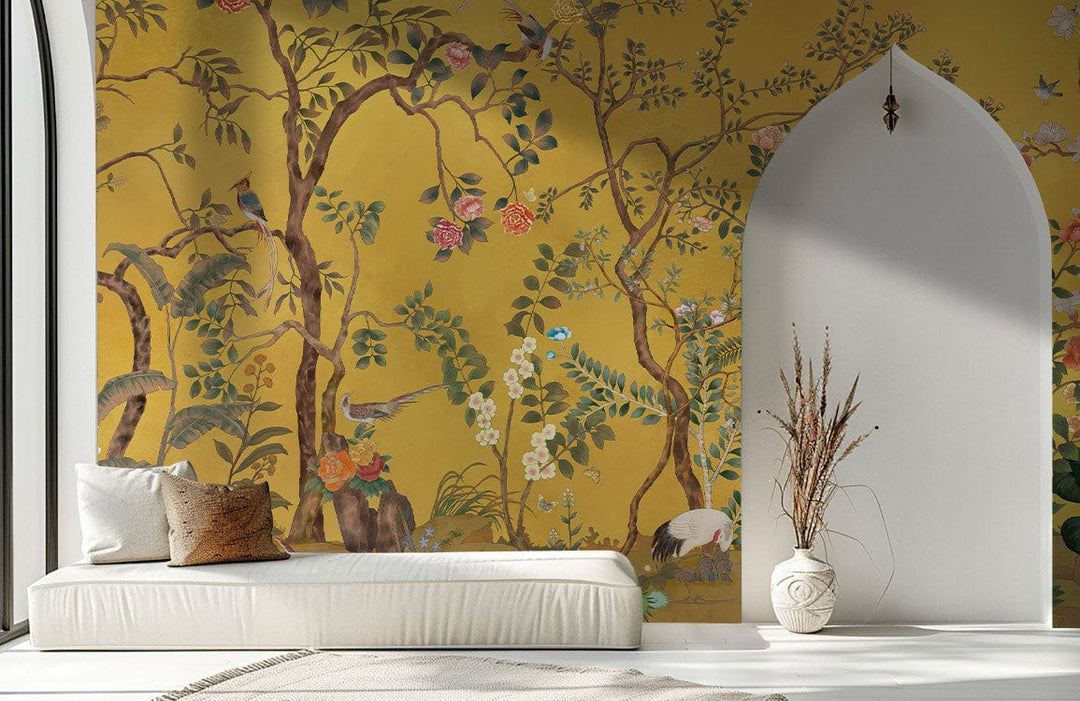 Golden Chinoiserie wallpaper with vibrant birds in living room, white daybed, minimalist decor, natural light.