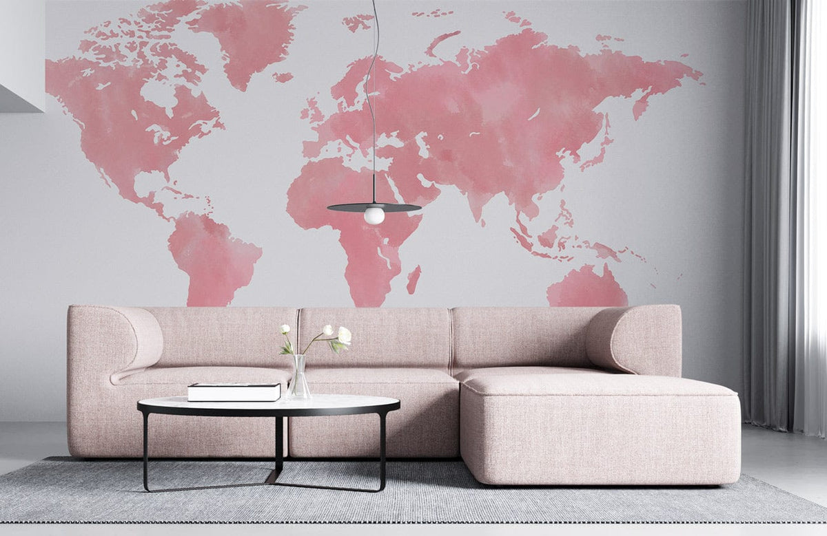 Blush Pink World Map Mural Wallpaper, modern grey room, stylish pink sofa, round black table.