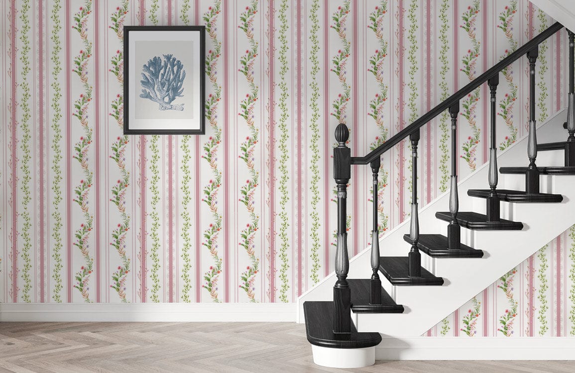 Elegant pastel pink floral striped wallpaper with vintage staircase; framed art; wooden flooring.