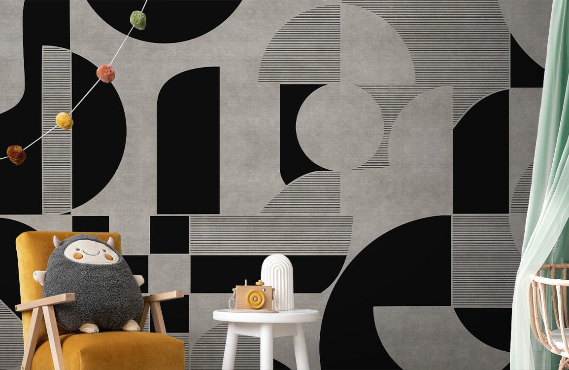 Geometric grey and black abstract wallpaper in modern interior with mustard armchair and playful decor.