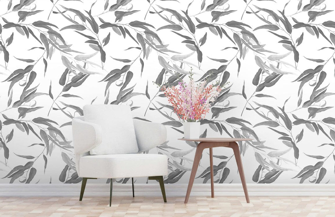 Elegant grey botanical leaf wallpaper, minimalist design, white armchair, wooden floor, modern living room.