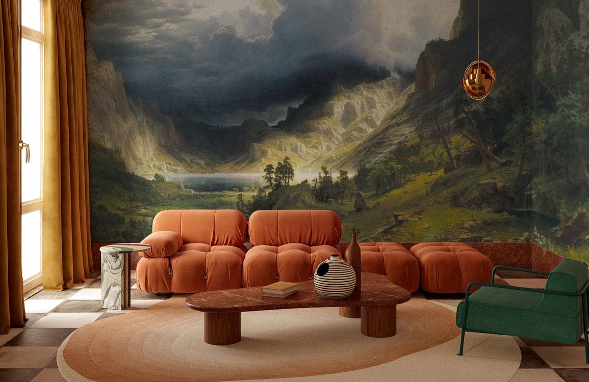 Scenic Mountain Valley Landscape Mural Wallpaper in living room with orange sofa, green armchair, checkered floor.