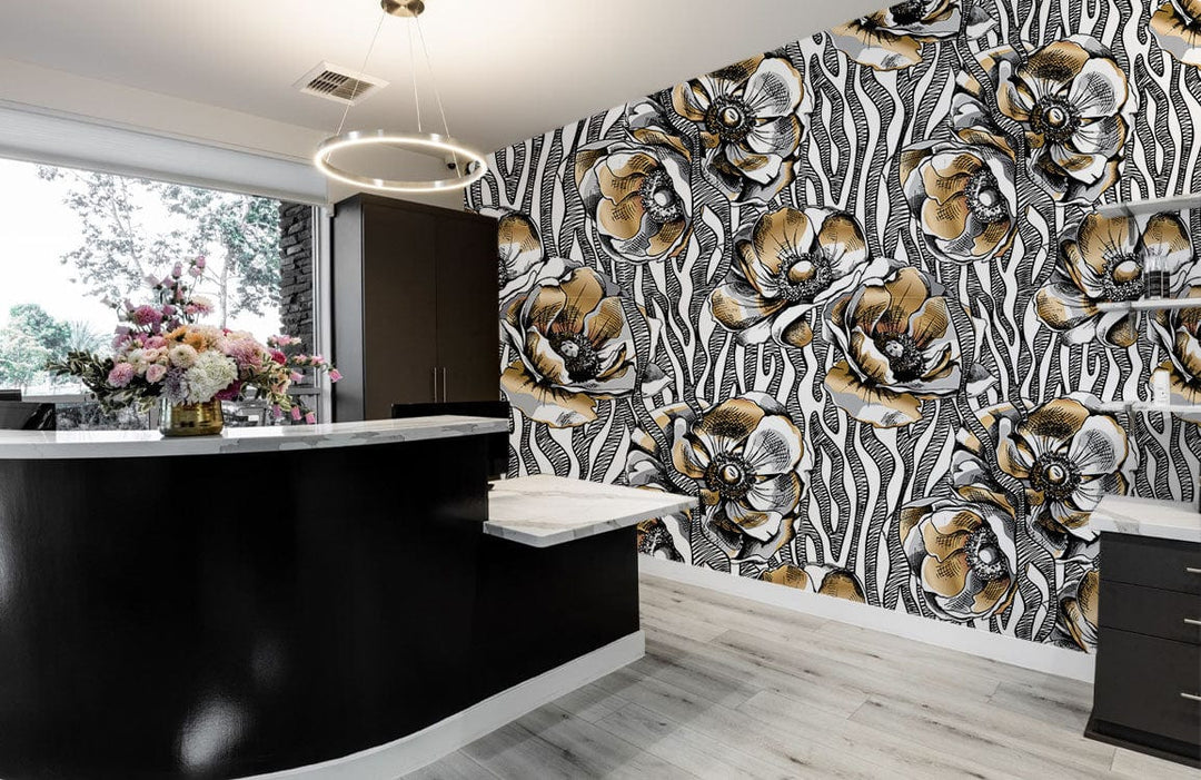 Vintage botanical wallpaper in black, gold; modern monochrome kitchen with dark cabinets, light wood flooring.
