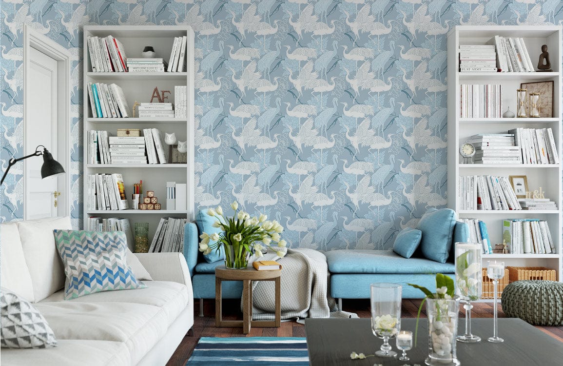 Sky Blue Origami Cranes Pattern Wallpaper in living room with white shelves, beige sofa, blue chaise.