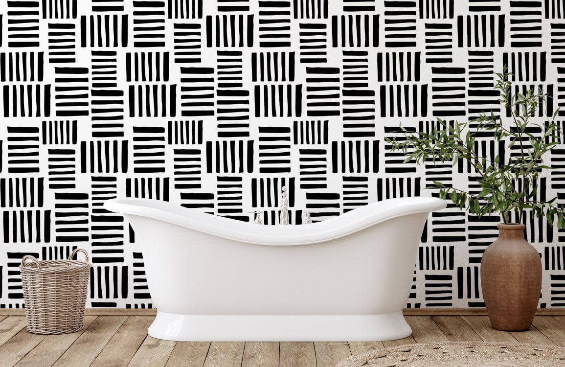 Monochrome geometric stripe wallpaper in bathroom with white tub, wooden flooring, and wicker basket.