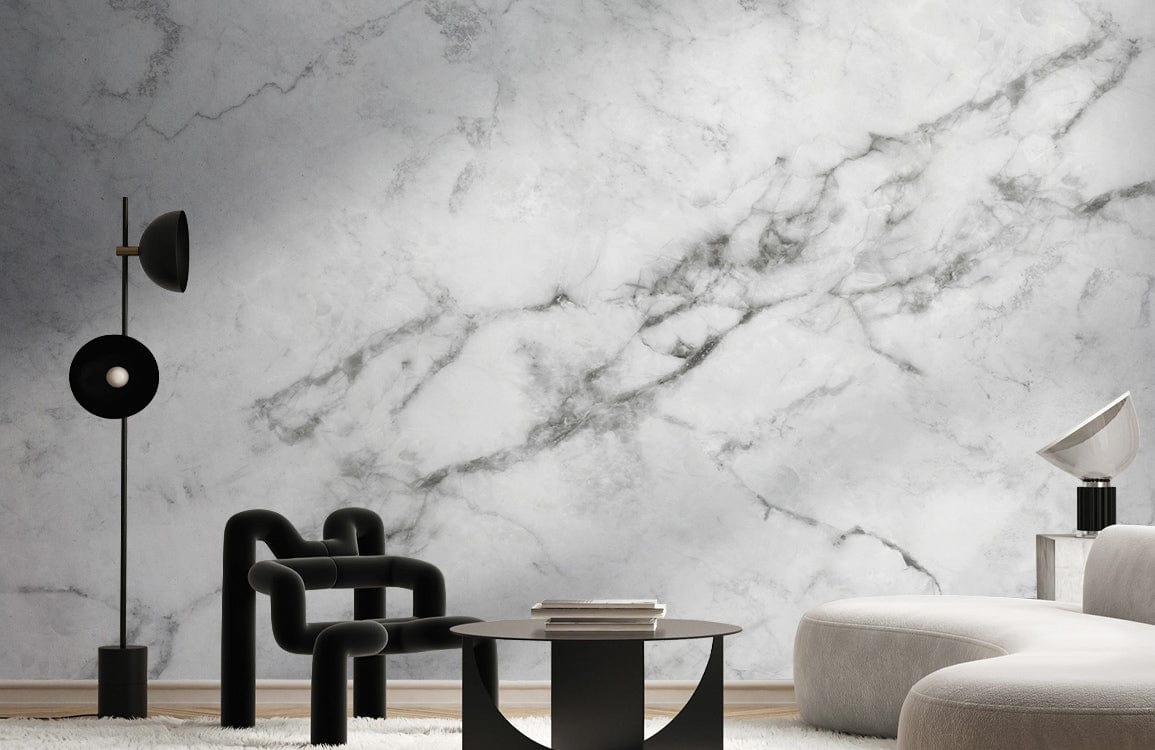 Elegant white marble effect wallpaper in modern living room with black armchair and curved sofa.