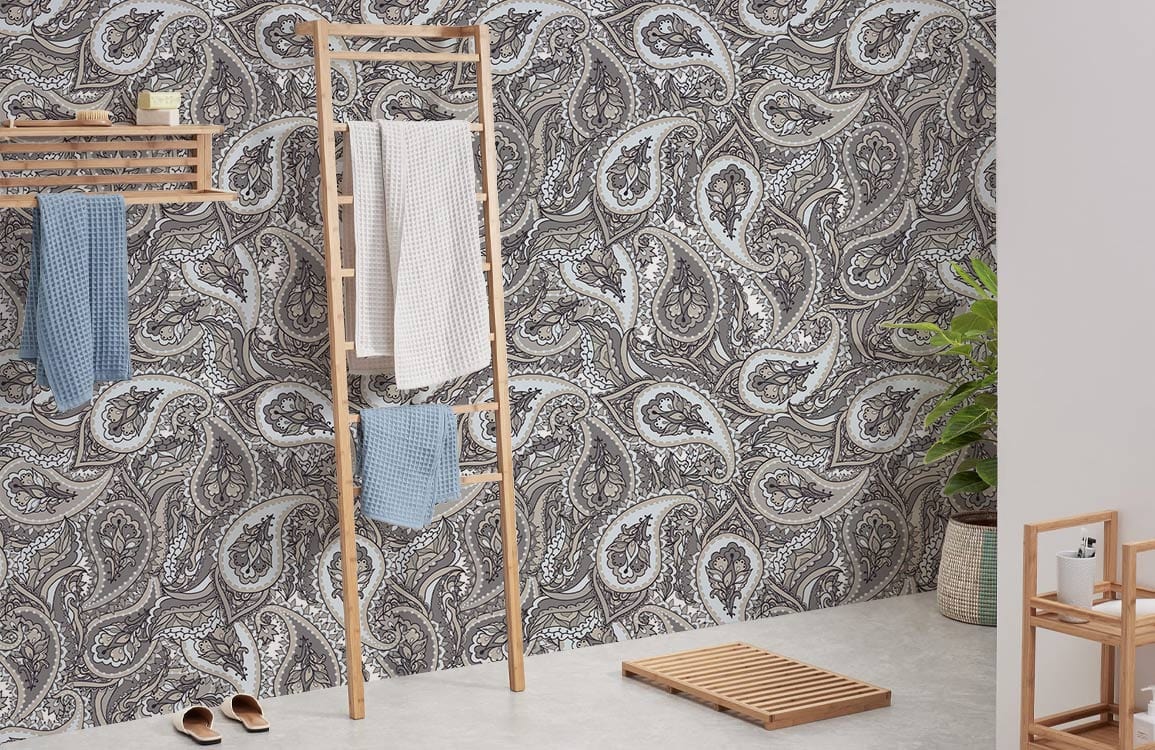 Elegant grey paisley wallpaper in modern bathroom, with wooden towel rack and light flooring.