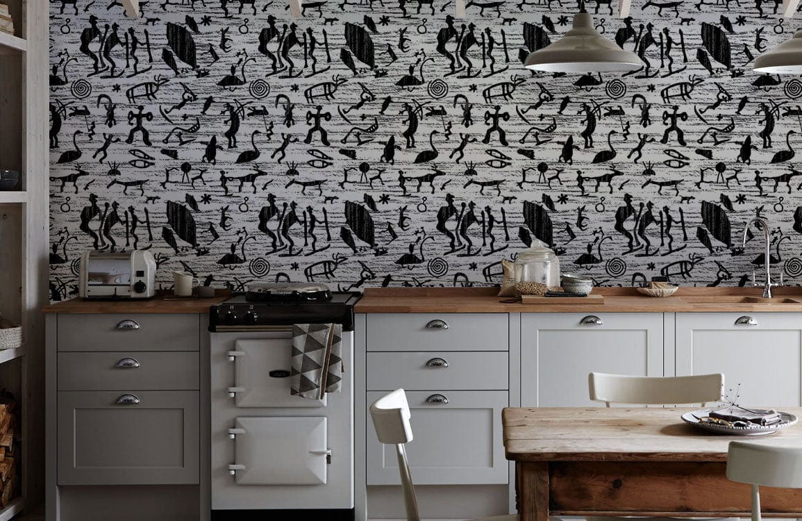 Monochrome Tribal Art Deco Wallpaper in kitchen with white cabinets, wooden table, and vintage cooker.