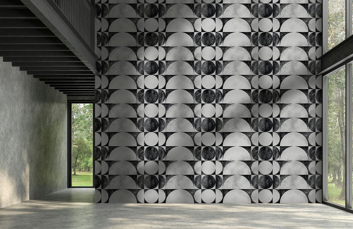 Black and white geometric wallpaper on modern feature wall in spacious minimalist room with large windows.