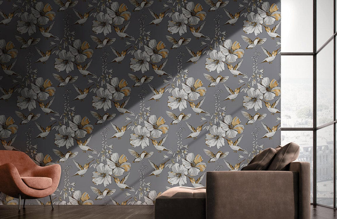 Elegant grey floral wallpaper with butterflies, modern botanical design, brown sofa, pink chair, wooden floor.