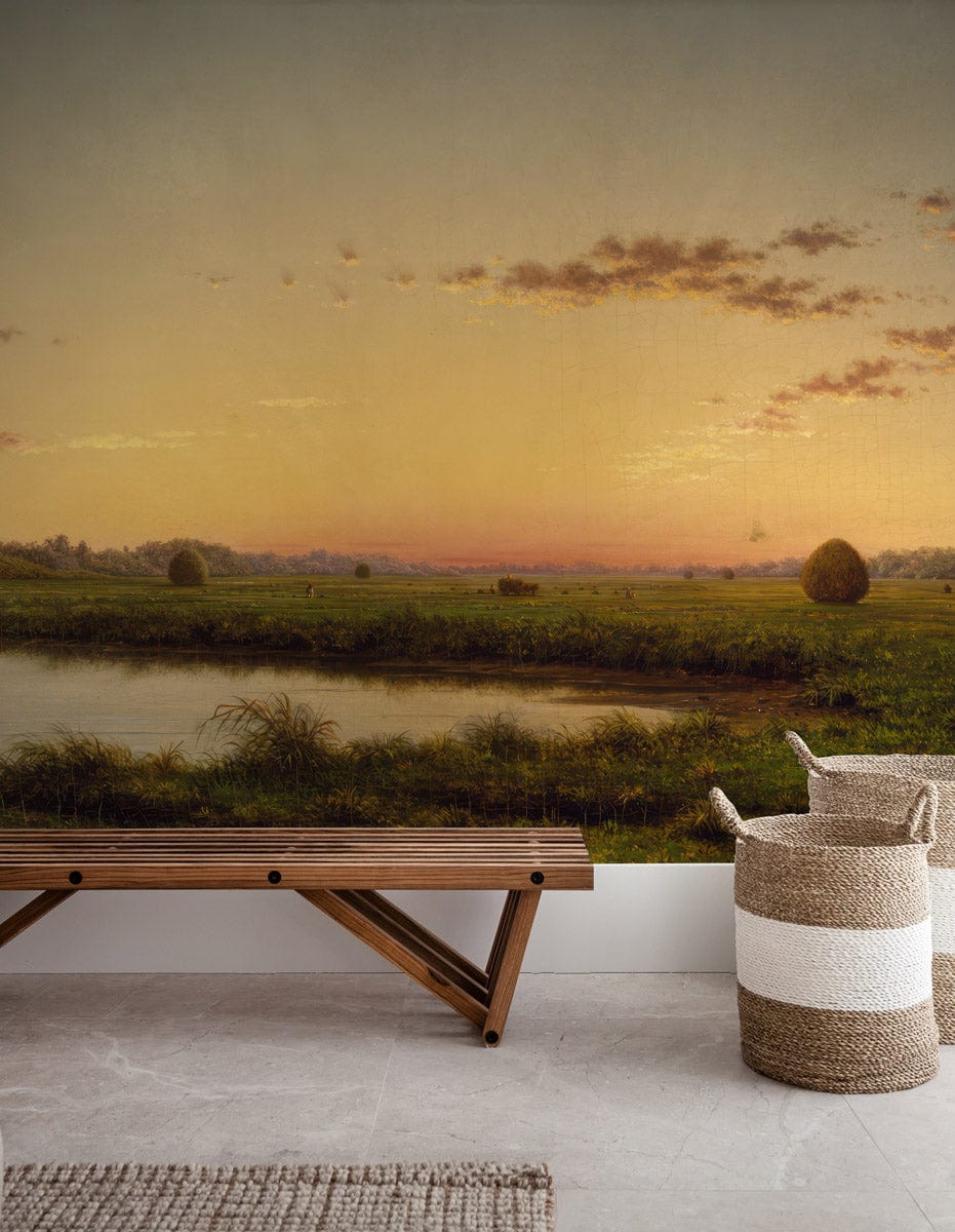 Serene Countryside Sunrise Mural Wallpaper with modern bench, woven basket, marble flooring in living room.