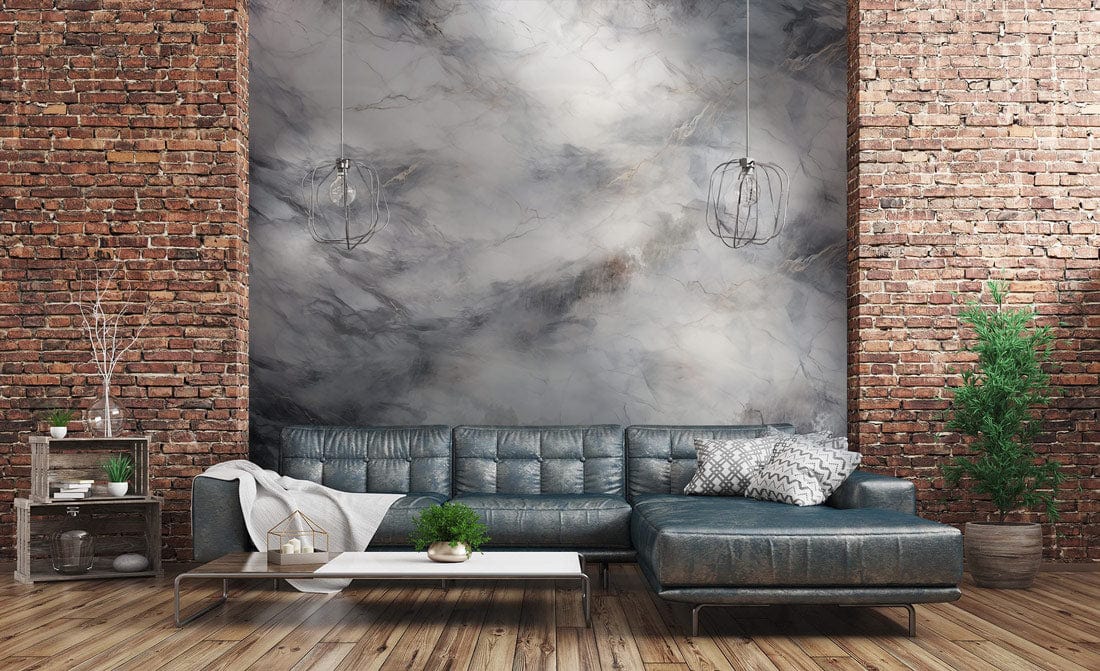 Luxury grey marble effect mural wallpaper with brick wall, dark leather sectional sofa, wooden flooring.