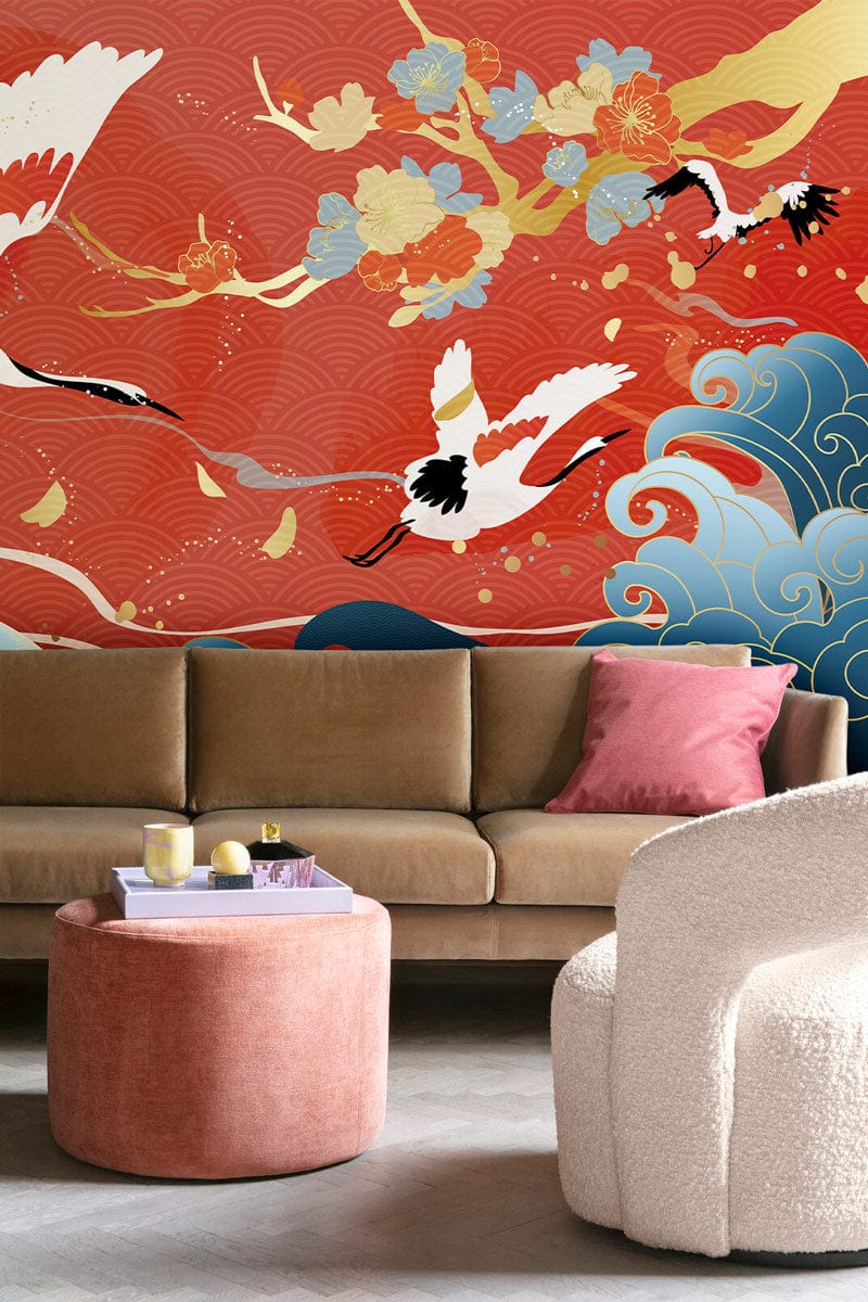 Luxurious living room with Japanese Crane Serenity mural wallpaper; beige sofa, pink ottoman, modern chair.
