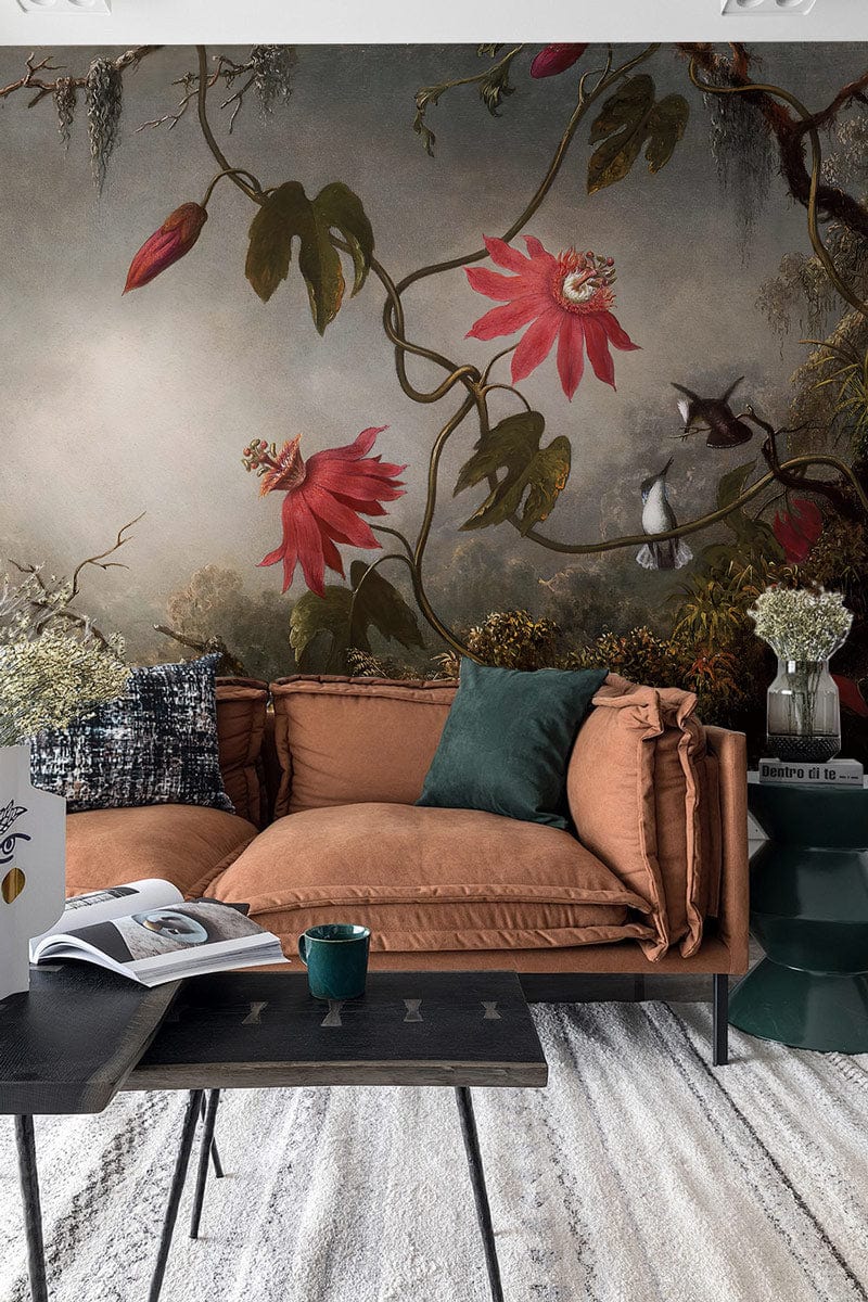 Vintage botanical mural wallpaper with red flowers and hummingbirds, displayed in modern living room setting.