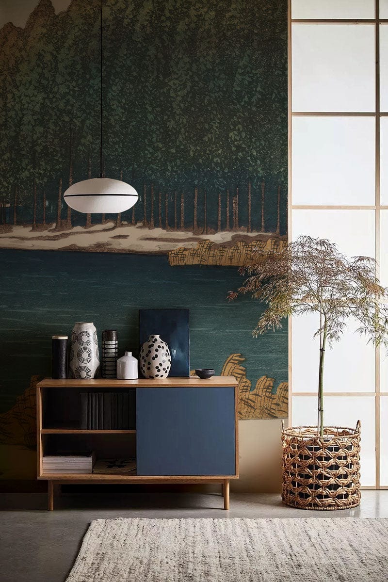 Serene Winter Lake and Pine Forest Mural, modern sideboard, pendant light, woven basket, cosy rug.