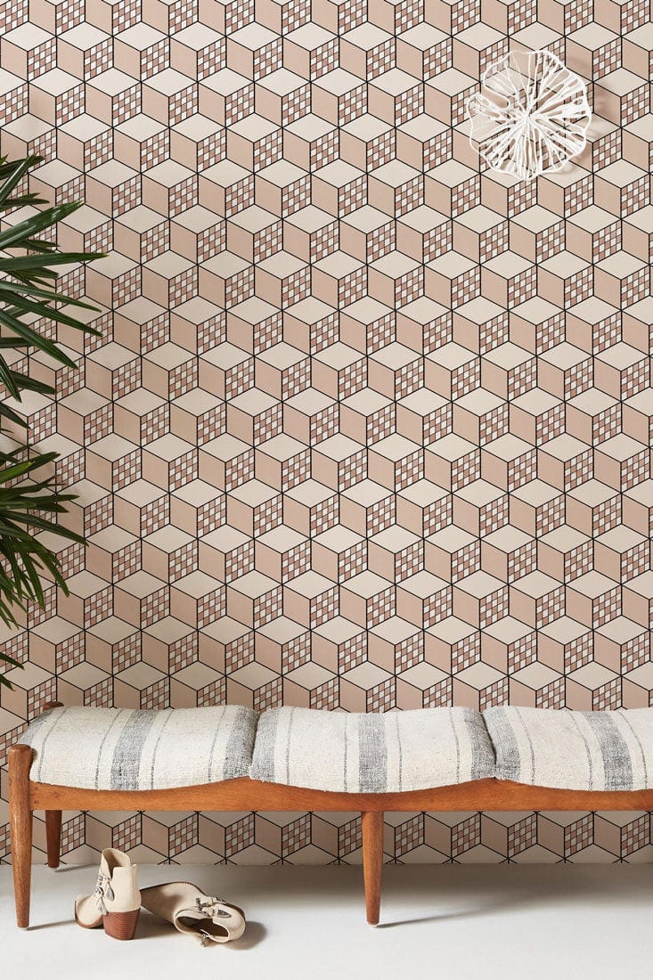 Taupe and white geometric cube wallpaper, with wooden bench and white cushioned seat in modern room.