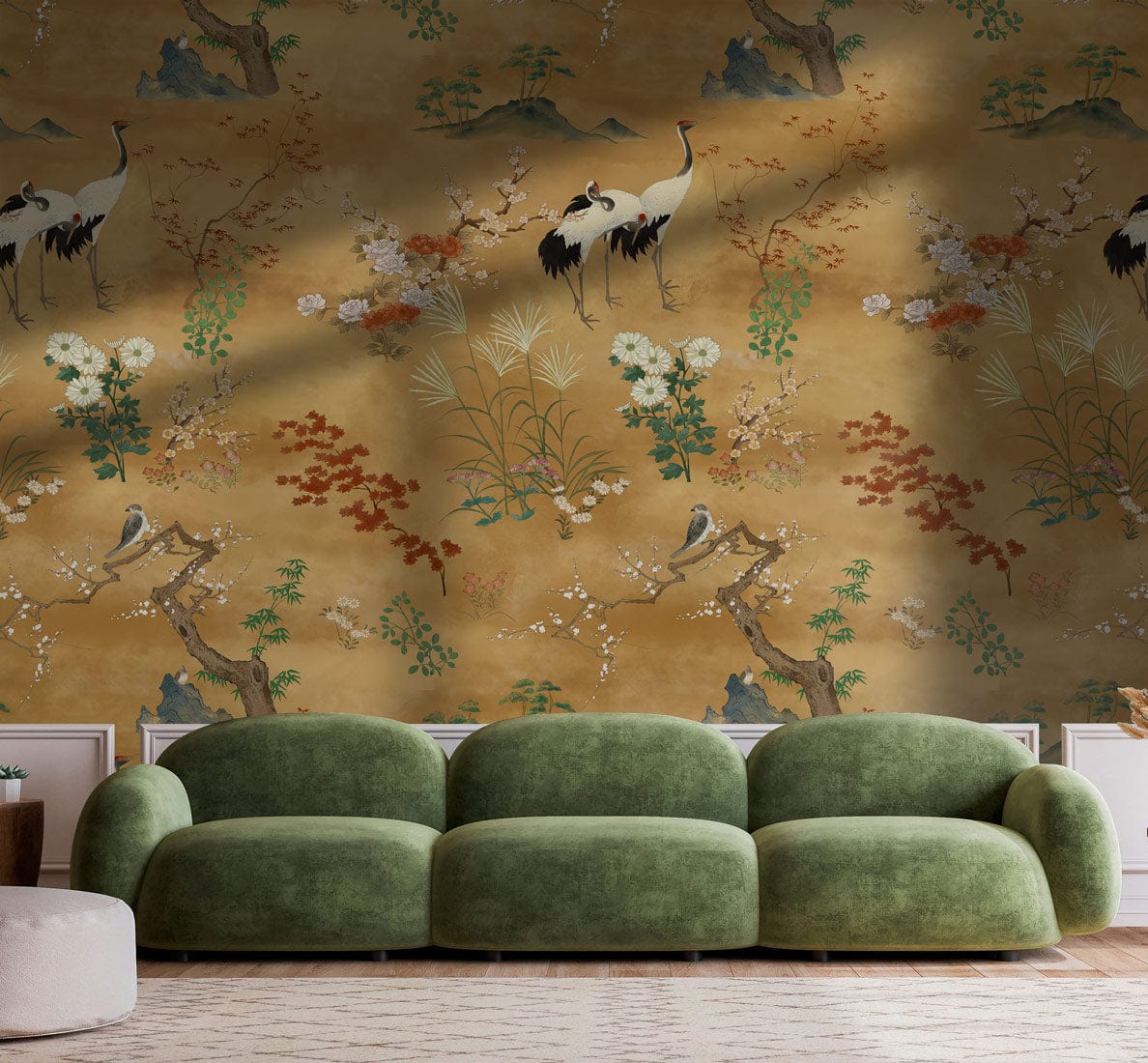 Elegant vintage wallpaper with cranes and florals; green sofa, wooden flooring, luxurious living room setting.