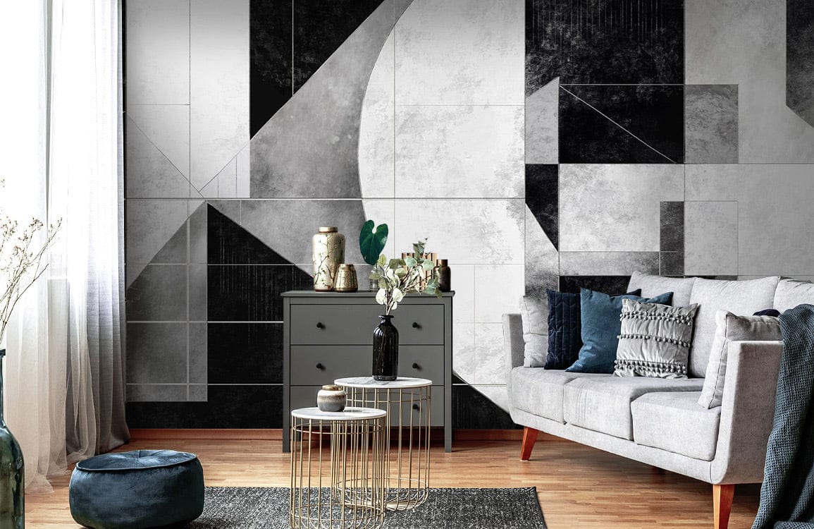 Monochrome geometric wallpaper mural in black and white, featuring grey sofa, wooden flooring, modern Décor.