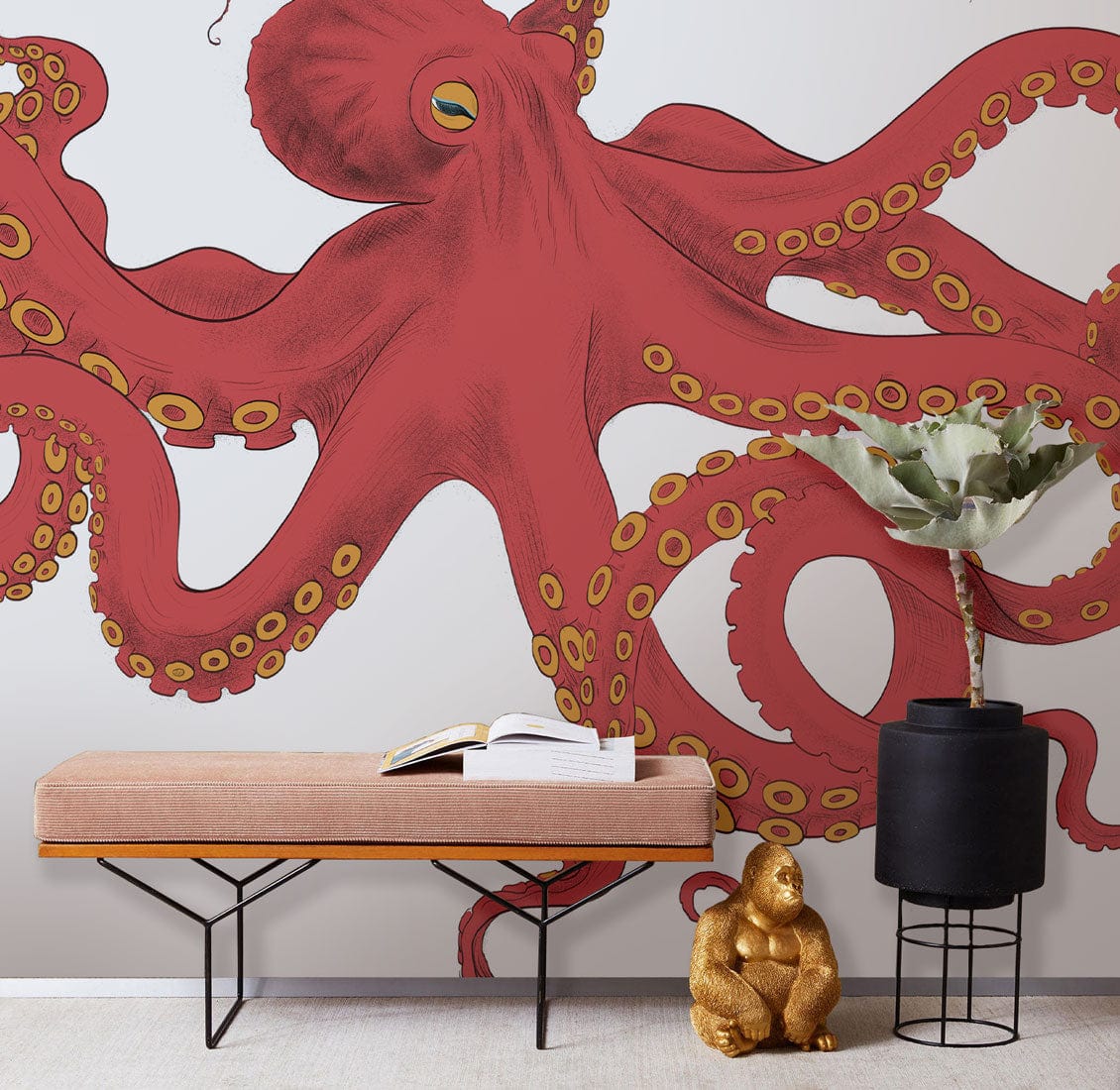 Vibrant Red Octopus mural wallpaper, beige sofa, black planter, gold decor, nautical theme room.