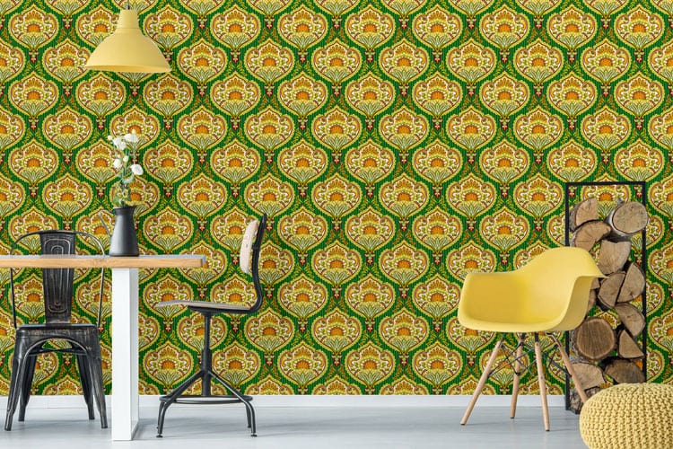 Luxurious green and gold vintage wallpaper in dining room with yellow chair, pendant light, and wood stack.