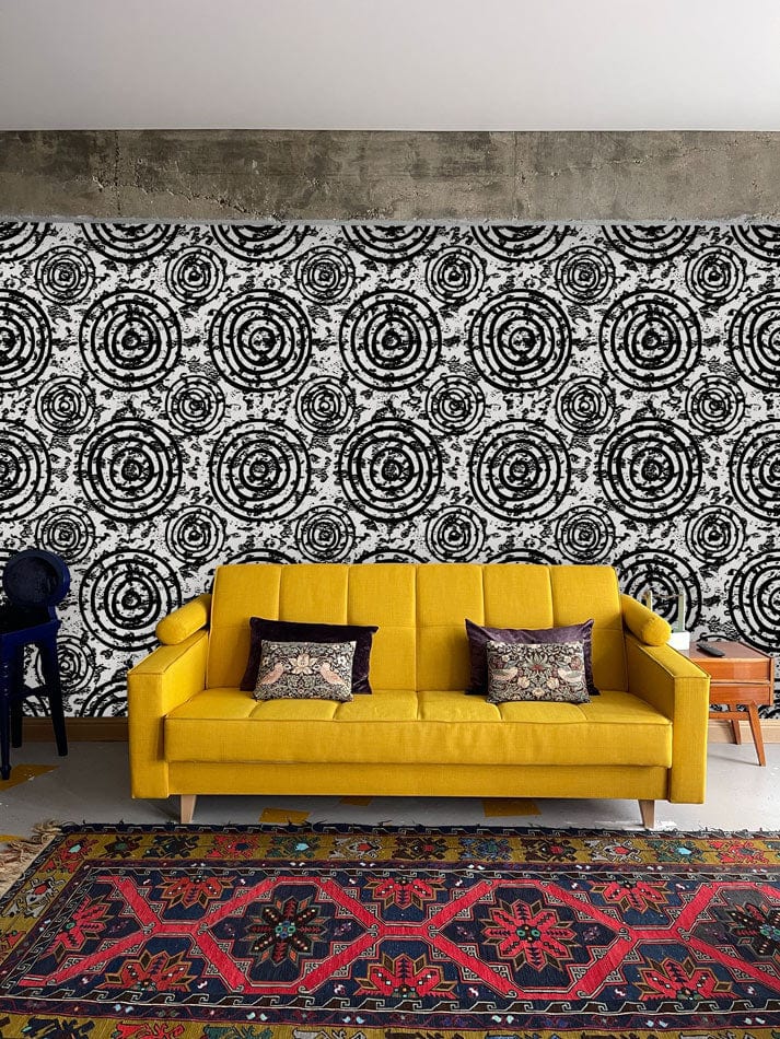 Yellow sofa, Monochrome Spiral Circles Geometric Wallpaper, vibrant patterned rug, modern living room design.