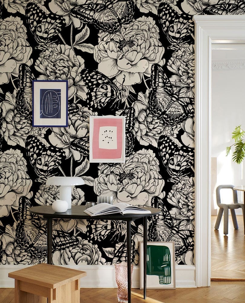 Monochrome botanical butterfly wallpaper, elegant hallway, black-and-white floral design, light wood herringbone flooring.