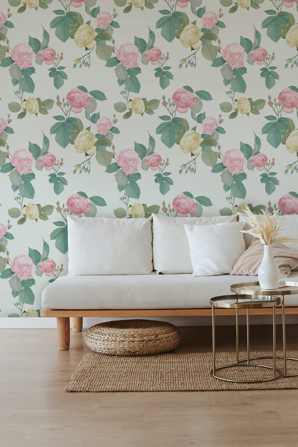 Vintage floral pastel wallpaper in pink and green, white sofa, wooden floor, modern living room.