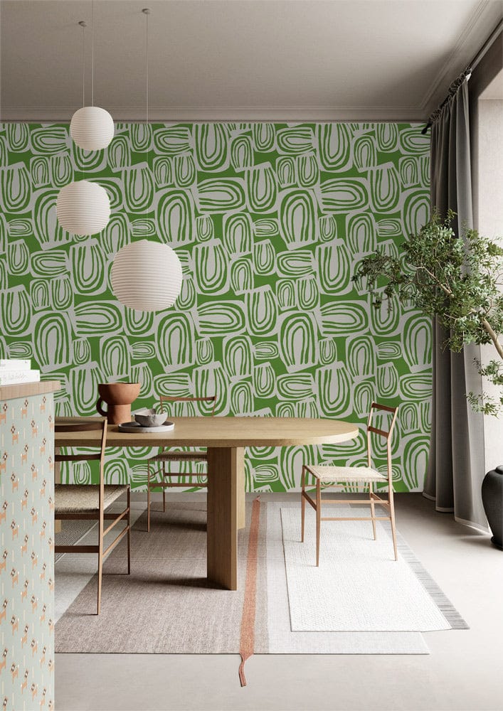 Contemporary dining room with green abstract geometric wallpaper, modern wood table, chairs, pendant lighting.